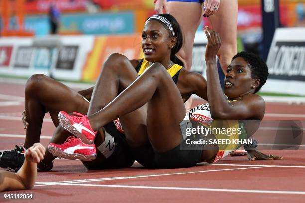 Jamaicas Janieve Russell celebrates with Jamaicas Ronda Whyte after Russell won the athletics women's 400m hurdles final during the 2018 Gold Coast...