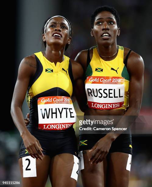 Janieve Russell of Jamaica looks on after winning gold with Ronda Whyte of Jamaica after the Women's 400 metres hurdles final during athletics on day...