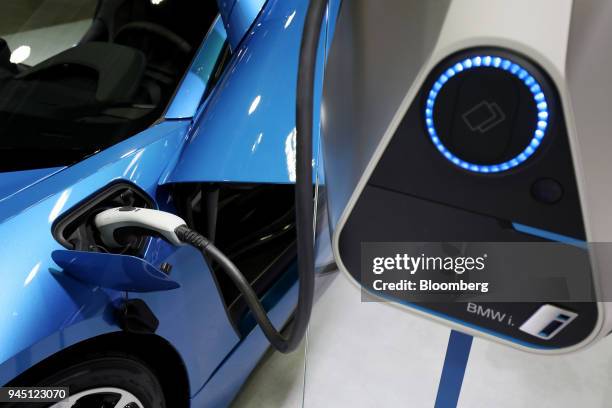 Charging cable is connected to a BMW AG i8 plug-in coupe vehicle at the EV Trend Korea exhibition in Seoul, South Korea, on Thursday, April 12, 2018....