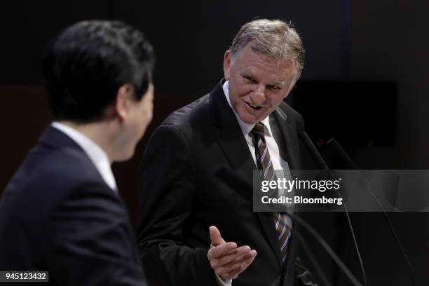 Andreas Renschler, chief executive officer of Volkswagen Truck & Bus GmbH, right, gestures to Yoshio Shimo, president and chief executive officer of...
