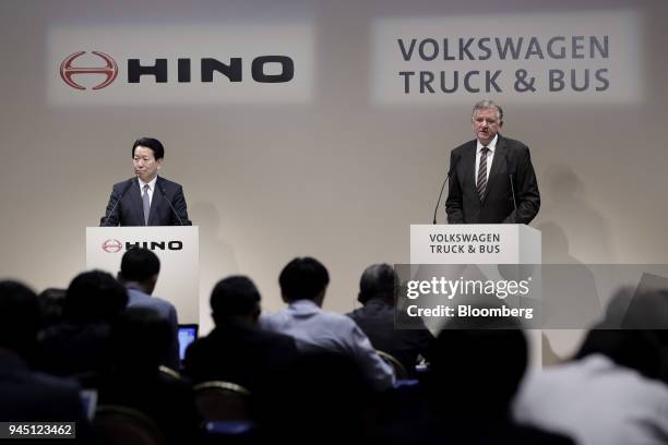 Andreas Renschler, chief executive officer of Volkswagen Truck & Bus GmbH, right, speaks while Yoshio Shimo, president and chief executive officer of...