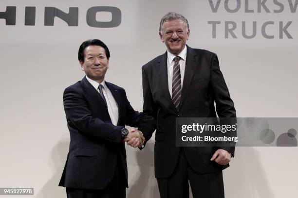 Yoshio Shimo, president and chief executive officer of Hino Motors Ltd., left, and Andreas Renschler, chief executive officer of Volkswagen Truck &...