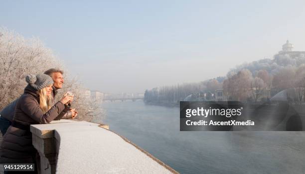couple take picture above river, winter, turin, piedmont, italy - turin stock pictures, royalty-free photos & images