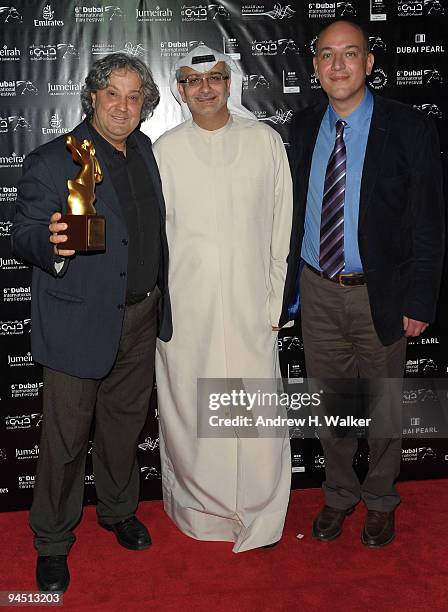 Director Michel Khleifi, Artistic Director of DIFF Masoud Amralla Al Ali and producer Omar Al Qattan with the Muhr Arab Best Film award for "Zindeeq"...