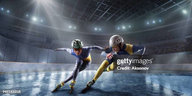 short track athletes slide in professional ice arena. fall of a skater - ice skater stock pictures, royalty-free photos & images