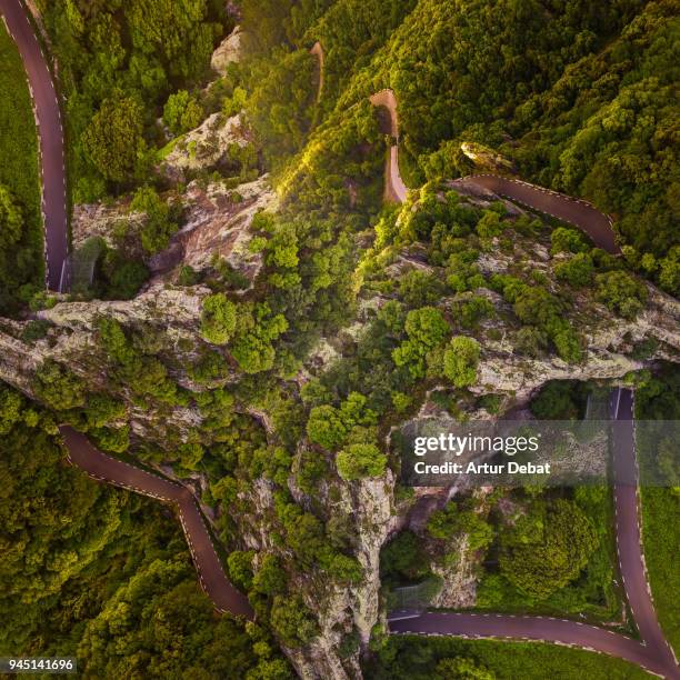 aerial view of surreal mountain road with curves upside down in the mountain landscape. - looking down the road stock pictures, royalty-free photos & images