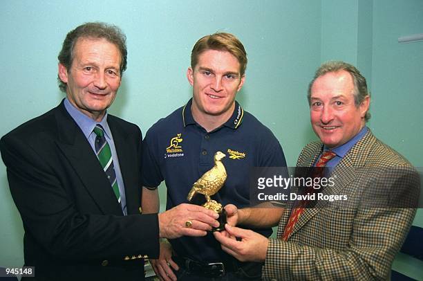 Peter Thomas owner of Cardiff, Tim Horan of Australia, and Gareth Edwards during the Rugby Union World Cup 1999 Famous Grouse player of the...