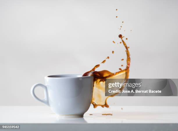 impact of a coffee cup that falls down on the table. - coffee spill stock pictures, royalty-free photos & images