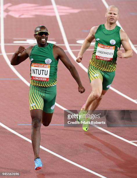 Ndodomzi Ntutu of South Africa crosses the line to win gold ahead of Hilton Langenhoven of South Africa in the Men's T12 100m Final during athletics...