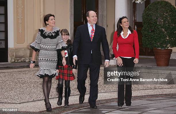 Prince Albert II of Monaco, Princess Caroline of Hanover, Princess Alexandra of Hanover and Princess Stephanie of Monaco prepare to distribute...