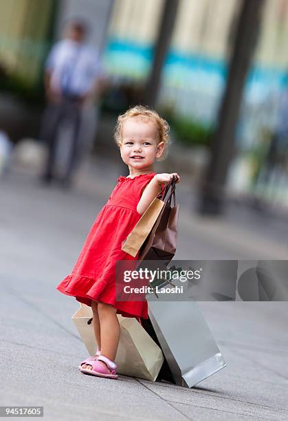 young girl with full of bags - laoshi stock pictures, royalty-free photos & images