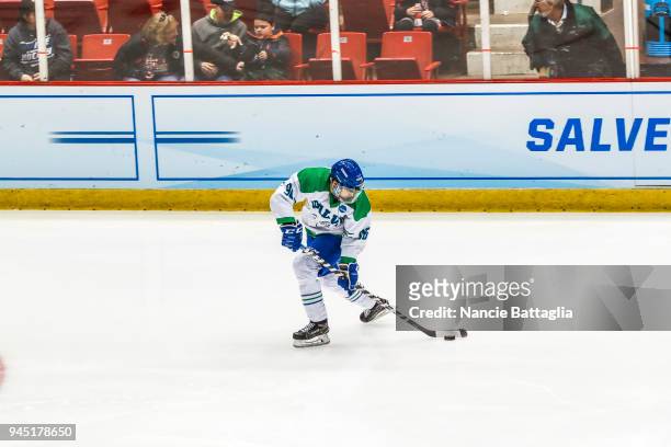 Danny Eruzione, of Regina Salve, gathers the puck during the Division lll Men's Ice Hockey Championship held at the Olympic Center on March 24, 2018...