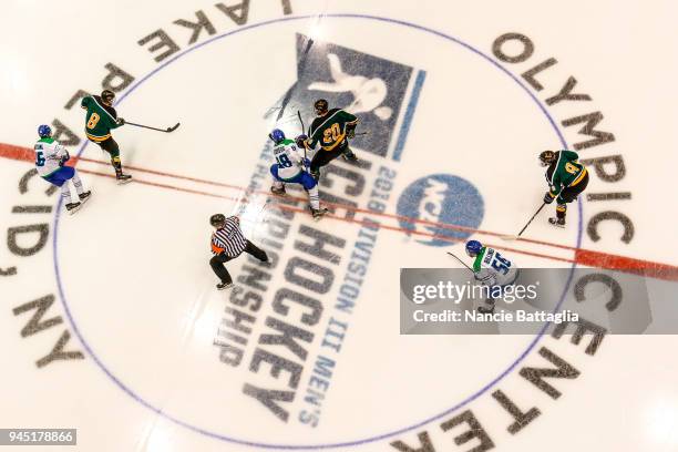 Players of Regina Salve and St. Norberg stand at center ice after a face off during the Division lll Men's Ice Hockey Championship held at the...