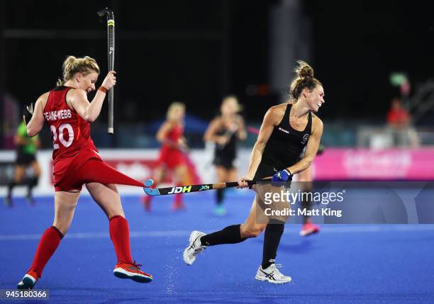 Kelsey Smith of New Zealand gets her stick caught on the shorts of Hollie Pearne-Webb of England during Women's Semi Final Hockey match between...