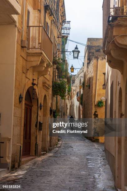 narrow winding street in rabat, gozo - gozo malta stock pictures, royalty-free photos & images