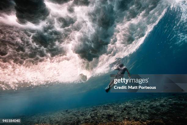free diver beneath breaking waves - duck dive stock pictures, royalty-free photos & images