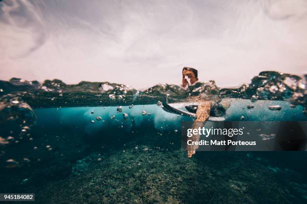 Surfer paddles out to sea