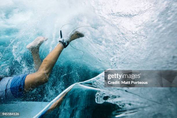 below the breaking waves - duck dive stock pictures, royalty-free photos & images