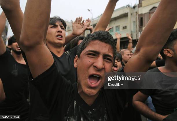 Shiite Muslim worshippers gather at the Imam Musa al-Kadhim's mosque in the Iraqi capitals northern district of Kadhimiya on April 12, 2018 as they...