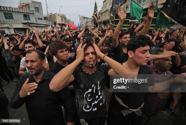 Shiite Muslim worshippers gather at the Imam Musa al-Kadhim's mosque in the Iraqi capitals northern district of Kadhimiya on April 12, 2018 as they...