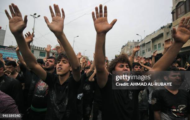 Shiite Muslim worshippers gather at the Imam Musa al-Kadhim's mosque in the Iraqi capitals northern district of Kadhimiya on April 12, 2018 as they...