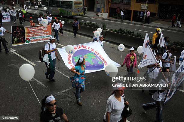 People take part in the 'World March for Peace and Non-Violence' in Bogota on December 16, 2009. The World March began in New Zealand on October 2,...
