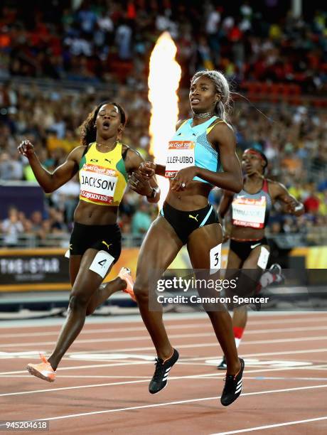 Shaunae Miller-Uibo of the Bahamas crosses the line to win gold ahead of Shericka Jackson of Jamaica in the Women's 200 metres final during athletics...