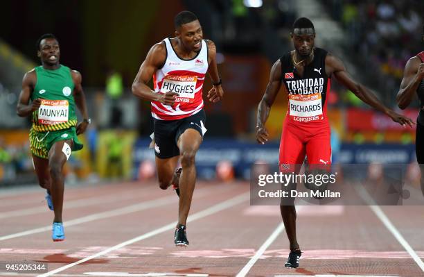 Zharnel Hughes of England crosses the line to win gold ahead of Jereem Richards of Trinidad and Tobago inthe Men's 200 metres final during athletics...