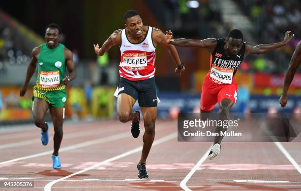 Zharnel Hughes of England crosses the line to win gold ahead of Jereem Richards of Trinidad and Tobago inthe Men's 200 metres final during athletics...