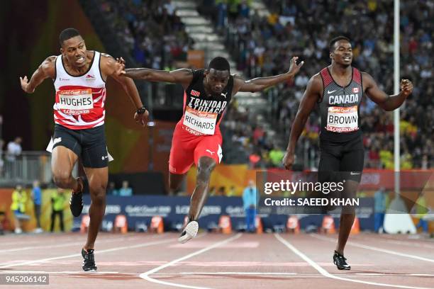 Englands Zharnel Hughes, Trinidad And Tobagos Jereem Richards and Canada's Aaron Brown cross the finish line of the athletics men's 200m final during...