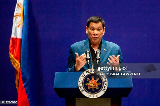 Philippines President Rodrigo Duterte speaks at an event with the Filipino community during his visit to Hong Kong on April 12, 2018. / AFP PHOTO /...