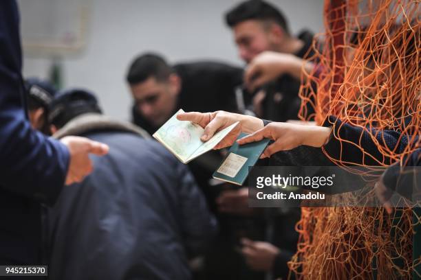 Palestinians wait in line for passport transactions to cross to Egypt following the opening of Rafah border gate in Khan Yunis, Gaza on April 12,...