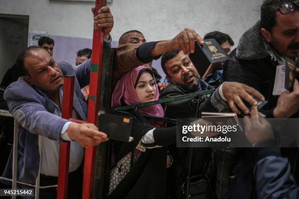 Palestinians wait in line for passport transactions to cross to Egypt following the opening of Rafah border gate in Khan Yunis, Gaza on April 12,...