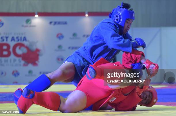 Giap Ngoc Thoan of Vietnam fights against Eranu Gusffi of Indonesia during their under 90 kg Combat Sambo at the 1st South East Asian Sambo...