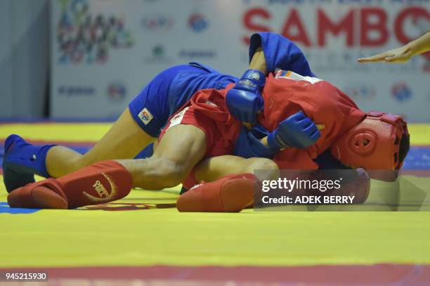 Patrick Manicad of the Phillipnes fights against Rais Sasli of Indonesia during their under 74 kg Combat Sambo at the 1st South East Asian Sambo...