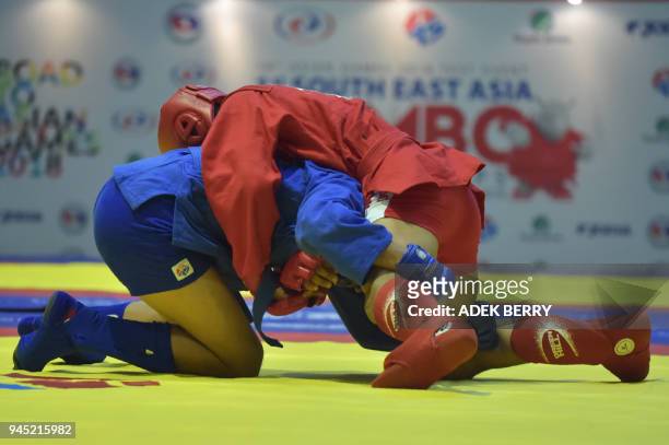 Patrick Manicad of the Phillipnes fights against Rais Sasli of Indonesia during their under 74 kg Combat Sambo at the 1st South East Asian Sambo...