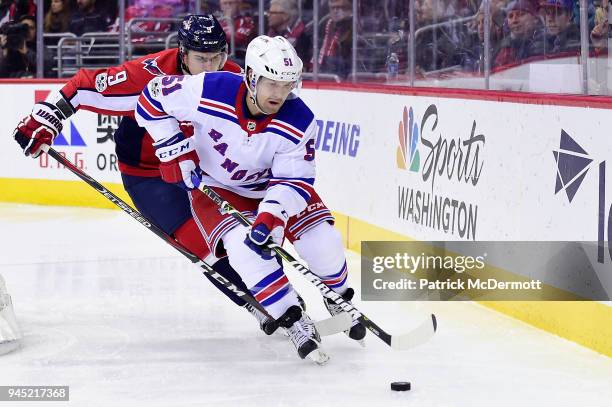 David Desharnais of the New York Rangers and Dmitry Orlov of the Washington Capitals battle for the puck in the second period at Capital One Arena on...