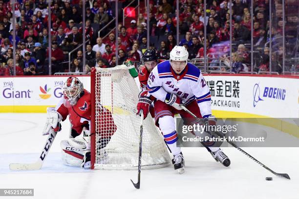 Jimmy Vesey of the New York Rangers and Brett Connolly of the Washington Capitals battle for the puck in the second period at Capital One Arena on...