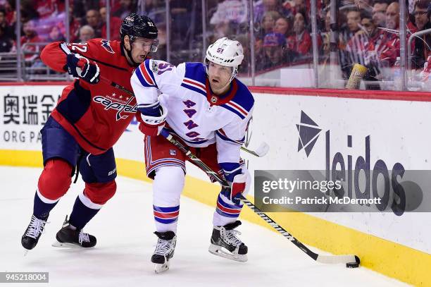 David Desharnais of the New York Rangers and Evgeny Kuznetsov of the Washington Capitals battle for the puck in the second period at Capital One...