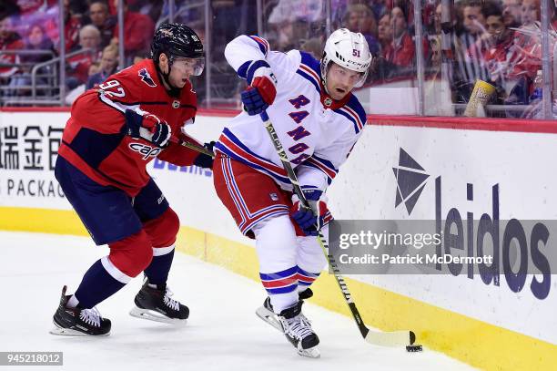 David Desharnais of the New York Rangers and Evgeny Kuznetsov of the Washington Capitals battle for the puck in the second period at Capital One...