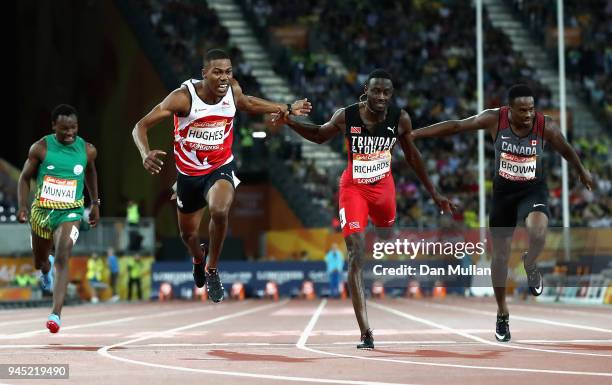 Zharnel Hughes of England crosses the line to win gold ahead of Jereem Richards of Trinidad and Tobago inthe Men's 200 metres final during athletics...