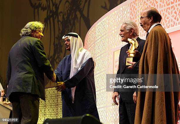 Director Michel Khleifi with the Muhr Arab Best Film award for "Zindeeq" onstage with DIFF Chairman Abdulhamid Juma and actor Omar Sharif and guest...