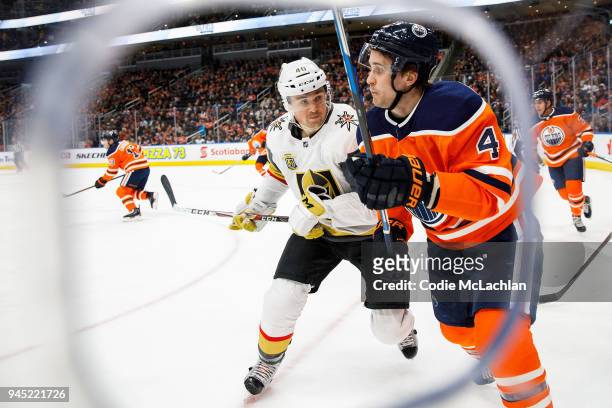 Kris Russell of the Edmonton Oilers battles against Ryan Carpenter of the Vegas Golden Knights at Rogers Place on April 5, 2018 in Edmonton, Canada.