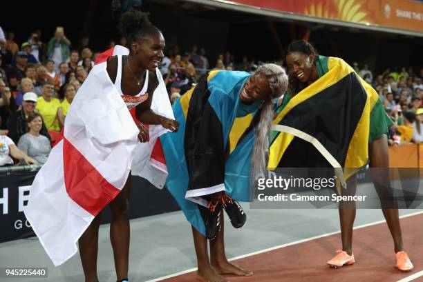 Bronze medalist Dina Asher-Smith, gold medalist Shaunae Miller-Uibo of the Bahamas and silver medalist Shericka Jackson of Jamaica celebrate after...