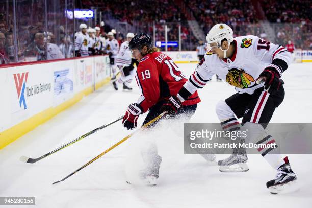 Nicklas Backstrom of the Washington Capitals and Artem Anisimov of the Chicago Blackhawks battle for the puck in the first period at Capital One...