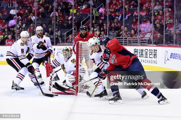 Jay Beagle of the Washington Capitals brings the puck around the net against Tommy Wingels of the Chicago Blackhawks in the first period at Capital...