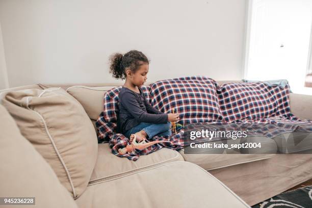 child playing alone at the living room - sectional sofa stock pictures, royalty-free photos & images