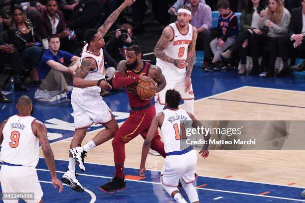LeBron James of the Cleveland Cavaliers drives to the basket against Frank Ntilikina and Lance Thomas of the New York Knicks during the game at...