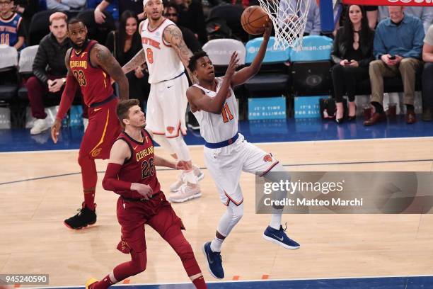 Frank Ntilikina of the New York Knicks lays up a shot against Kyle Korver of the Cleveland Cavaliers during the game at Madison Square Garden on...