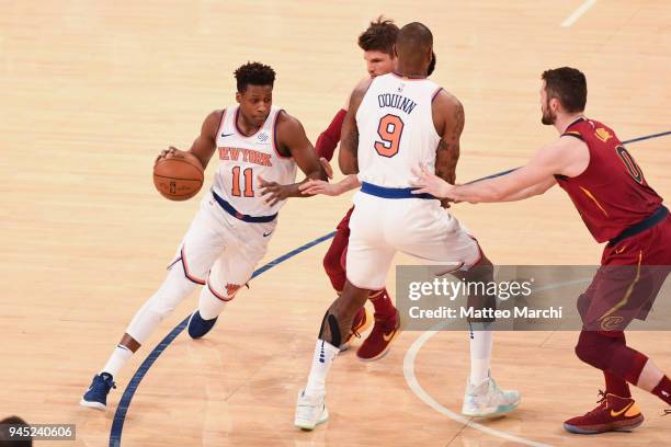 Frank Ntilikina of the New York Knicks handles the ball against Kyle Korver of the Cleveland Cavaliers during the game at Madison Square Garden on...